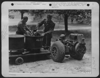 General > FRANCE-Except for the rubber tires, this washing machine was made entirely of abandoned German equipment by U.S. Army 9th Air Force Service Command mechanics, Sgts. Eugene McLaughlin (left). Sparland, Ill., and Peter Gambutt, Mt. View, N.J.