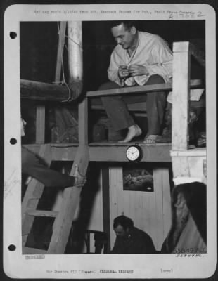 General > Climbing the ladder to the second floor of a Pyramidal tent "Shackteau" built by men at a Ninth Air Force fighter-bomber base in France, Lt. Robert J. Todd of Tampa, Fla., finds Lt. Arthur F. D'Agostino of Newark, N.J., beating him to the sack.