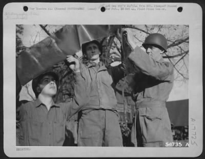 Operations & Mapping > FRANCE-Photo Reconnaissance film is inspected after they return from a mission over enemy territory at a Ninth Air Force base somewhere in Europe. Left to right are: Pfc Carl A. Forsman, Olympia, Wash.; T/Sgt Arba Harper, Lawton, Okla.; and John