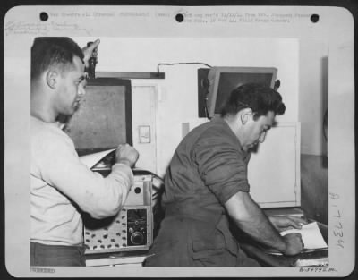 Processing > Two 9th AF enlisted men, Harris Levy (left) of N.Y.C. prints and Martin H. Stoll, of Brooklyn, N.Y., develops the prints in a Photo Recon Unit Lab at a 9th AF base somewhere in France.