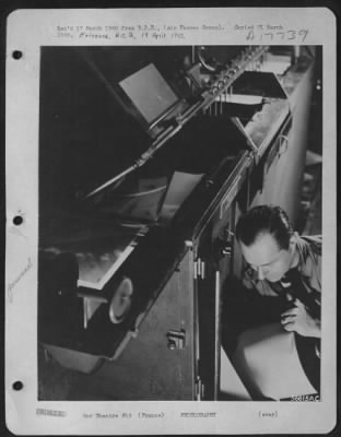 Processing > FRANCE--The multiprinter goes to work. Paper which comes in 1000 ft. rolls is loaded according to negative contrast. Sgt. John Hellas, of Jacksonville, Florida, places the roll in the machine.