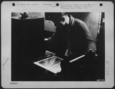 Processing > FRANCE--Printer head is adjusted. Negative is judged for density thru the viewer so that proper print exposure can be made. Pfc. Edward Speaks, of Ridgeland, Miss., gives the final adjustment of printing light intensity before the bulk order is