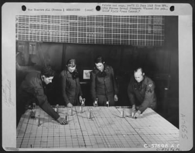 General > The Markers On The Numbered Plotting Table Refer To The Number Of The Raid And Number Of Planes Participating In A Mission.  Men In The Picture Are: (Left To Right), Cpl. William Saver Of Brooklyn, N.Y.; Pfc. Raymond Emmerick Of Shamokin, Pa.; Sgt. Ellis