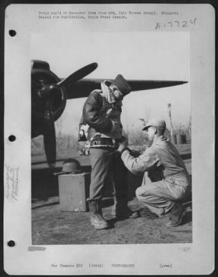 Thumbnail for Operations & Mapping > Air Force Mechanic Adjusts Lt. Francis J. Burgess' Parachute As He Prepares To Leave On A Mission Over Enemy-Held Territory To Photograph An Allied Bombing Mission.  Lt. Burgess Is From 716 N. Irving Blvd., Los Angeles, Calif.