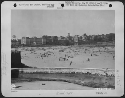 General > Beach At Dinard, France, Showing Underwater Obstacles Placed By Nazis To Deter Amphibious Operations By Allied Troops.  Hotels In The Background Once Housed Tourists Visiting This Beauty Spot.  15 August 1944.