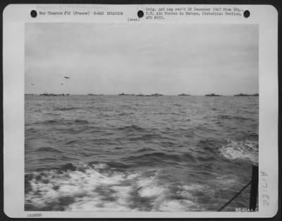 General > An Invasion Fleet Is Protected By A Balloon Barrage And Gun Fire Of Allied Naval Units From The Sea During A Large Scale Landing Somewhere On The Coast Of France In June 1944.