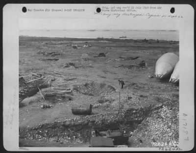 General > General View Of Normandy Beach, France After The D-Day Invasion.  Note The Numerous Bomb Craters Along The Battle-Scarred Beach.  22 June 1944.