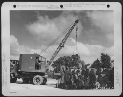 Thumbnail for Construction- Airfields > Just A Few Miles Behind The Front Lines In Normandy, France, Men Of The 9Th Air Force Aviation Engineers Constructed Emergency Landing Strips Within A Few Days From The Capture Of Enemy-Held Areas.  Here, Men Use A Crane For Loading "Hessian Mat" Onto A T