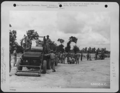Construction- Airfields > Just A Few Miles Behind The Front Lines In Normandy, France, Men Of The 9Th Air Force Aviation Engineers Constructed Emergency Landing Strips With "Hessian Mat" Used For Surfacing.  After The Selected Site For The Airstrip Is Graded And Leveled, The Mat,