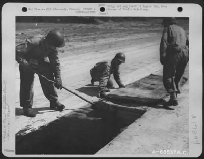 Construction- Airfields > Just A Few Miles Behind The Front Lines In Normandy, France, 9Th Air Force Aviation Engineers Constructed Emergency Landing Strips With 'Hessisn Mat' Used For Surfacing.  After The Selected Site For The Airstrip Is Graded And Leveled, The Mat, A Tar-Paper