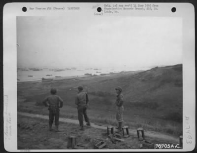 General > Three Men Of The 834Th Engineer Aviation Battalion Look Over Landing Operations At Normandy Beach, France.