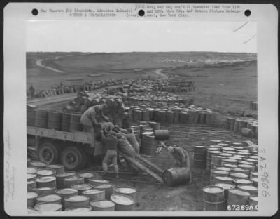 Consolidated > Loading barrels of fuel on a truck at the fuel dump of an 11th Air Force base near Amchitca, Aleutian Islands. 12 October 1943.