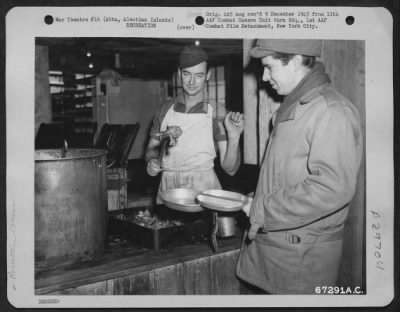 Consolidated > "Here's a drumstick for you," says the cook to a "GI," stationed on Attu, Aleutian Islands, one of the loneliest spots in the world. It was the first Thanksgiving dinner served on any former American territory recaptured from the Japanese.