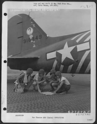 Thumbnail for Consolidated > Crew Members Study Their Map Before Boarding Plane To Participate In The Invasion Of Rangoon, Burma On 19 April 1945.  India.