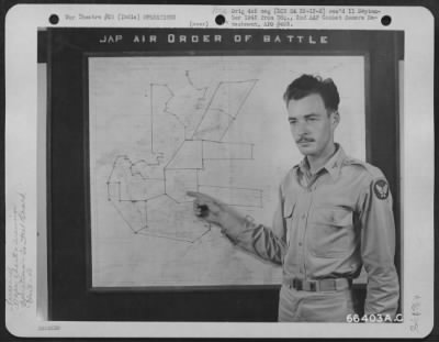 Consolidated > Lt. Francis J. Cahill, Intelligence Officer Of The 40Th Bomb Group, Points To A Wall Chart Showing Jap Air Order Of Battle - One Of The Wall Panels In The War Room At A 20Th Bomber Command Base In India.  These Panels Keep The Men Informed On The Latest D
