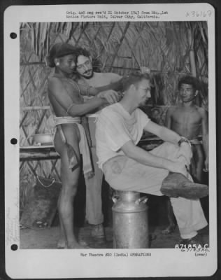 Consolidated > In Addition To His Other Duties, Pvt. Morris Glieberman Of New York City Was Barber For The Yank Expedition.  Here, He Teaches Naga Headhunters To Cut Hair, Using Pfc. Jack Elston Of Salt Lake City, Utah As The Victim.  The Purpose Of The Expedition Was T