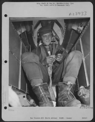 Consolidated > S/Sgt. Clarence M. Baumgartner, tail gunner from Evansville, Indiana, checks his guns before take-off on a mission from his base somewhere in North Africa. 29 July 1943.