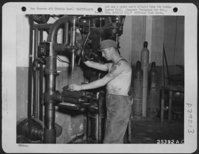 Consolidated > Pvt. George Green of Philadelphia, Pa., rebores the bushings from an American Liberator engine. He is a member of a Ninth U.S. Air Force Provisional Depot Repair unit which is trained to completely rebuild, when necessary, the giant motors that power