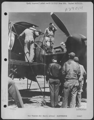 Consolidated > Tired and weary after flying a long mission at high altitude, Capt. Arthur D. Powers of Whitewater, Wis., is shown here leaving his plane as camera repairmen and mechanics swarm around.