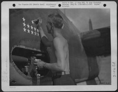 Thumbnail for Consolidated > 1st Lt. C.W. Gustafon of Worcester, Mass., painting another star on his plane has been on.