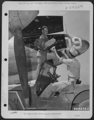 Thumbnail for Consolidated > When this Lockheed F-5 returned to its base in North Africa, from a photo reconnaissance mission, an intelligence officer and camera man met the plane in a jeep to take care of the exposed film. The men are: PFC N.W. Peterson (with camera)