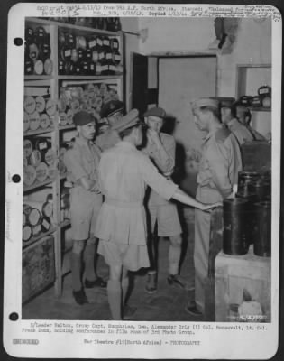 Consolidated > S/Leader Walton, Group Capt. Humphries, Gen. Alexander Brig (?) Col. Roosevelt, Lt. Col. Frank Dunn, holding conferences in film room of 3rd Photo Group.