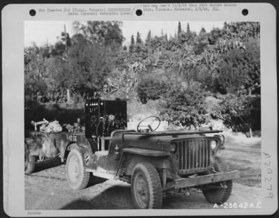 Consolidated > Tunis, Tunisia-Portable radio station on jeep and trailer, stripped down ready to load in a Douglas C-47.