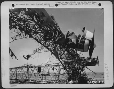 Consolidated > Tunis, Tunisia-Bones of the ME-323, left at El Aouina Airdrome, show the site and construction of this giant. At the left is a side view, together with remains of two of its six Gnome Rhone 14-cylinder, 850 H.P. twin row radial engines. The length is