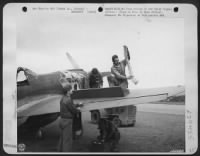 Loading a "Flying Tiger" P-40 with 50 cal. Machine gun bullets is done immediately as ship lands. Lt. James Perryman supervises the loading of the airplane. - Page 1