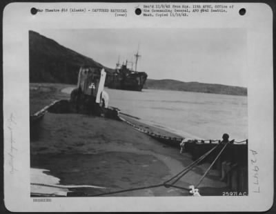 Consolidated > "BOGGED DOWN--BEACHED AND BROKEN" is one way to describe the pictorial scene here, furnished by the Japs in their fourteen month effort to obtain a foothold in the Aleutian Islands. In the foreground, is a Japanese landing barge, washed ashore