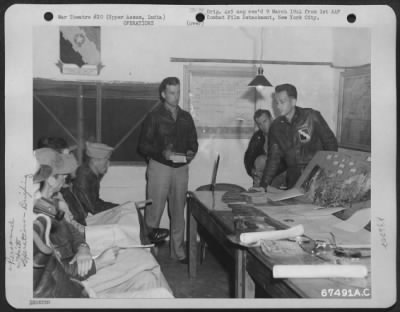 Consolidated > Lt. B. Shuman (Left) Of L.I., New York, Intelligence Officer Of The 80Th Fighter Group, And Major Stanton Smith, (Center), Operations Officer Of The 89Th Fighter Squadron, Briefs Pilots Before A Raid On Enemy Installations.  Uper Assam, India, February 19