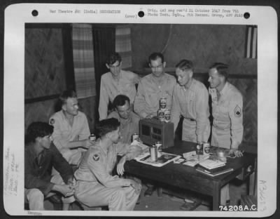 Consolidated > Men Of The 492Nd Bomb Squadron, 7Th Bomb Group, Listen To The Latest News Over A Radio At Their Base In India.