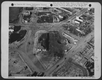 Consolidated > Market area in Baguio, suffered one direct hit and two near misses. Note the small craters from light bombs-probably 100 pounders. Earth was of soft dirt. Luzon, Philippine Islands. 27 April 1945.