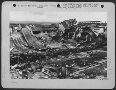 Consolidated > Bomb damage to refinery building and oil drums at the Philippine Coconut Oil Refinery on Mactan, Philippine Islands, 12 1945.