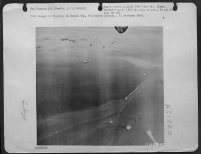 Consolidated > Bomb damage to shipping in Manila Bay, Philippine Islands. 15 February 1945.