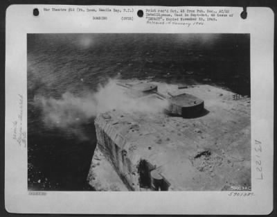 Consolidated > The gun turrets on Fort Drum, in Manila Bay, are silenced after the March 5th, 1945 low-level attack by the 345th Bomb Group. Half a blasted gun-barrel lies on the rear edge of the deck.