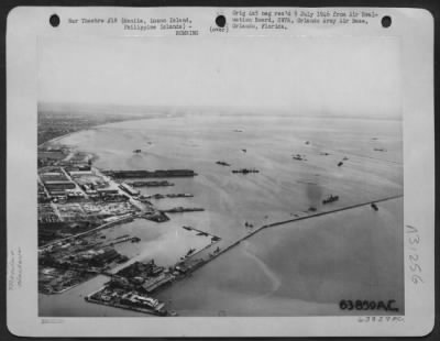 Thumbnail for Consolidated > Manila South Harbor, Engineer Island and the Inner Basin looking SSW. The inner basin is formed by a protective levee which may be seen extending from the lower left--to the right of the photograph are sunken enemy ships. February 1945.