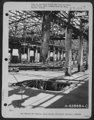 Thumbnail for Consolidated > An interior view of Pier #7, Manila Harbor, showing the destruction by Japanese demolition. The hole seen in the center of the photo was effected by an American Air Force bomb. February 1945.