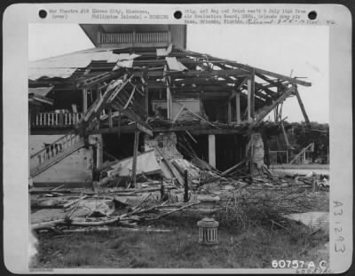 Consolidated > Remains of Municipal Building at Davao City, Mindanao, after Allied air attack. Although there was no bomb crater, the building suffered one direct hit completely demolishing the corner shown here. Philippine Islands.