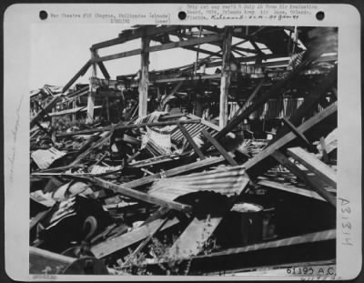 Consolidated > The machine shop of the Lopez Sugar Central at Fabrica, Negros Island, Philippine Islands, was demolished by our air raid. The Japs were distilling alcohol here for fuel. 25 May 1945.