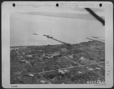 Consolidated > From this aerial view of Ormoc an idea can be obtained of the size and general layout of the town. Note: the "string" of bomb craters across the bottom of the photo. Ormoc, Leyte, Philippine Islands, 1945.