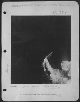 Consolidated > Burning from direct thousand-pound bomb hits, a Japanese cruiser of the Kuma class circles in a desperate effort to evade new blows by a "Bomber Baron" Liberator formation of the 13th AAF, which attacked it in the Sulu Sea Oct 26, 1944. Left burning