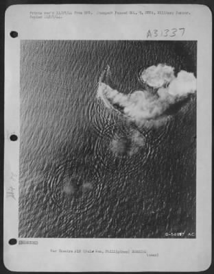 Consolidated > Burning from direct thousand-pound bomb hits, a Japanese cruiser of the Kuma class circles in a desperate effort to evade new blows by a "Bomber Baron" Liberator formation of the 13th AAF, which attacked it in the Sulu Sea Oct 26, 1944. Left burning