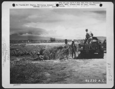 Consolidated > In order to prevent Malaria, Filipinos, under the direction of 37th Malaria Control Unit, spray oil on a small stream near Bacolod Airstrip, Negros, Philippine Islands. 14 June 1945.