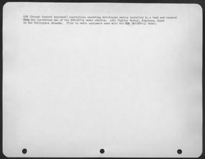 Consolidated > GCA (Ground Control Approach) controllers operating Air-Ground radios installed in a tent and remoted from the operations van of the SCR-527-A radar station. 45th Fighter Sector, Alaminos, Luzon in the Philippine Islands. (This is radio equipment