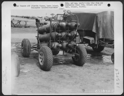 Consolidated > Mounted on pneumatic tires that easily traverse rough ground, the oxygen trailer can be towed either by jeep, tug, or truck to the airplane being maintained on the flight line. Florida Blanca, Luzon Island, August 1945.