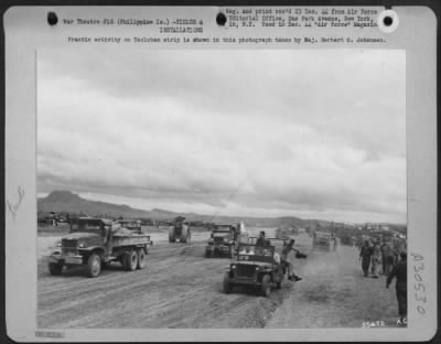 Consolidated > Frantic activity on Tacloban strip is shown in this photograph taken by Maj. Herbert O. Johansen.