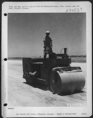 Consolidated > Roller "rolling" surface of strip at Clark Field, Luzon, Philippine Islands. 30 April 1945.