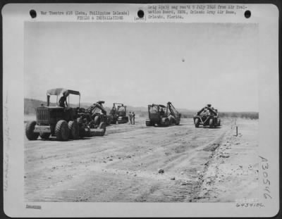 Consolidated > During reconstruction of Lahug Airstrip, a bulldozer pulls carry-all and a grader levels the surface. Cebu, Philippine Islands, May 1945.