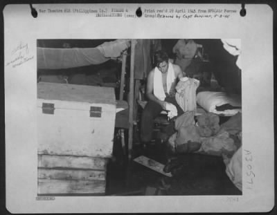 Consolidated > Housekeeping is a problem, this "Jungle Air Force" man will admit. The rain didn't quite come up to his cot, but all his belongings on the floor were soaked. A fast-moving air force, the 13th rarely stays long enough on one island to build